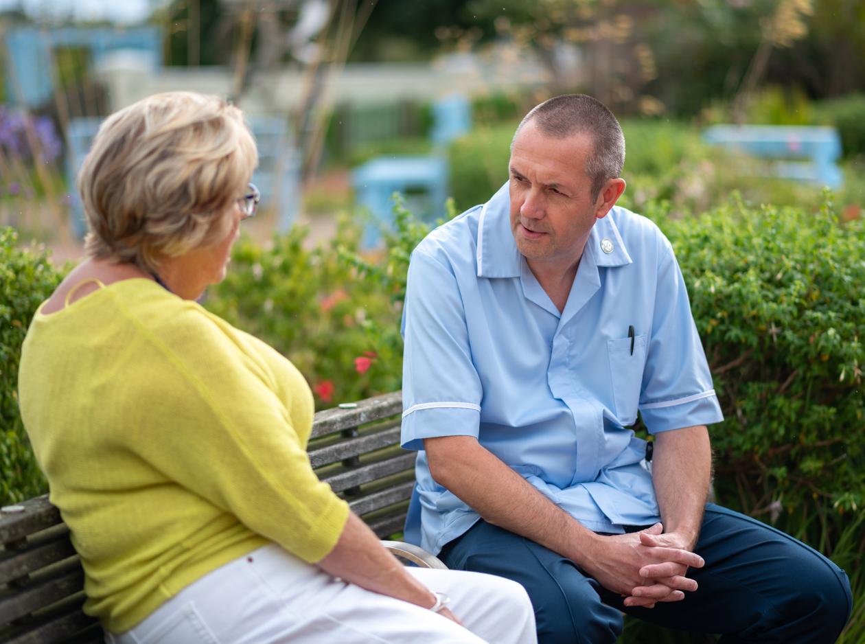 Patient talking to a member of the nursing staff whilst outdoors