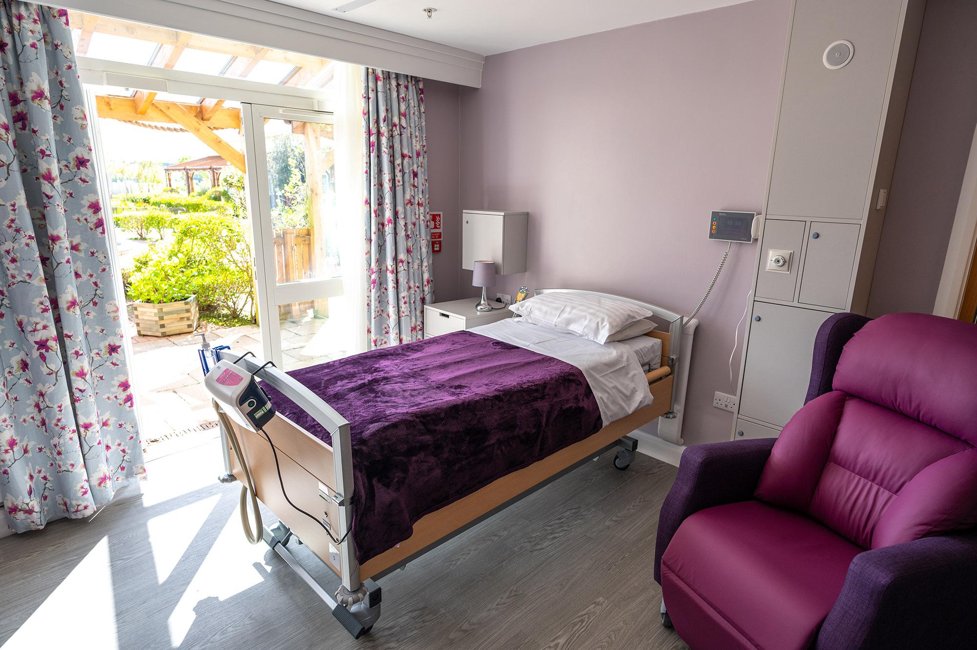 Photo of a bed within a patients room