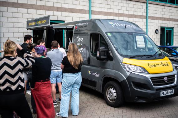 Customers queuing for the Care for a Drink van